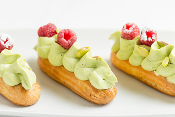 Eclair with pistachio cream and strawberries