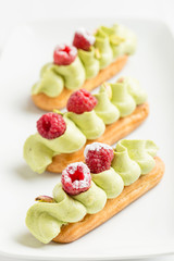 Eclair with pistachio cream and strawberries