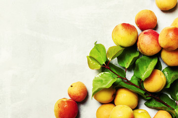 Fresh apricots with leaves, top view