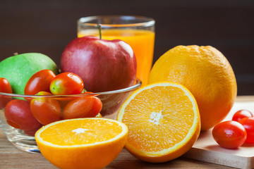 Healthy concept with mixed fruits and vegetables on wooden background