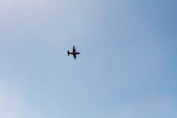 Fototapeta na wymiar Fire fighting plane silhouette in the blue sky