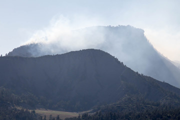 Smoke of a forest fire over the silhouette of mountains in Durango, Colorado