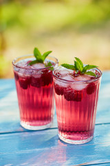Red drink with raspberry and leaves mint