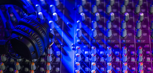 Microphone and Headphones on dirty sound mixer panel