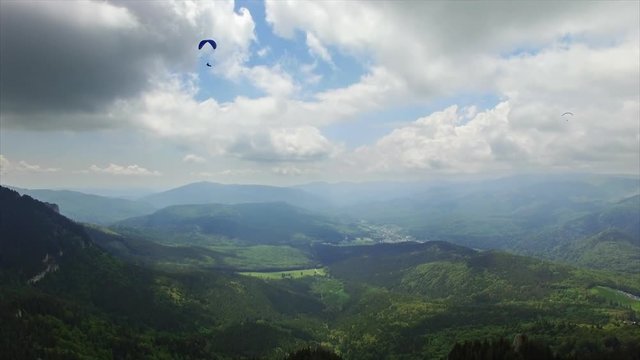 Aerial Paragliding over Mountains and Valleys