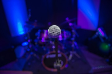 Fototapeta na wymiar Microphone on stage against a background of auditorium