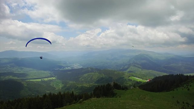 Aerial Paragliding over Mountains and Valleys