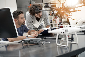 Fototapeta premium Engineer and technician working together on drone in office