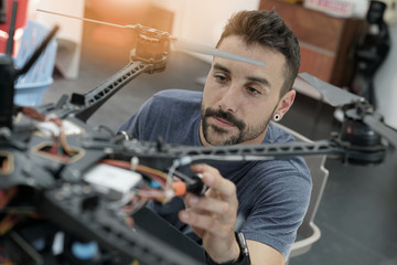 Engineer working on drone in lab