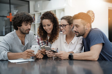 Young people having fun using smartphones