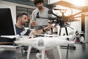 Fotobehang Engineer and technician working together on drone in office © goodluz