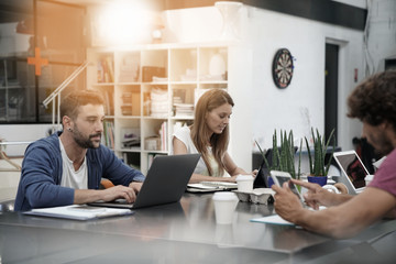 Trendy young people working in co-working office