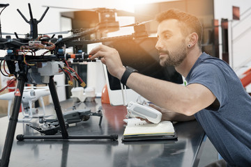 Engineer working on drone in lab
