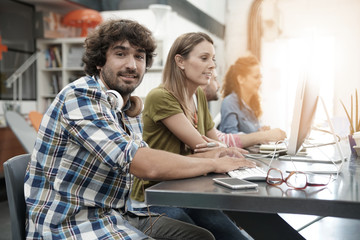 Start-up people working on desktop in co-working space