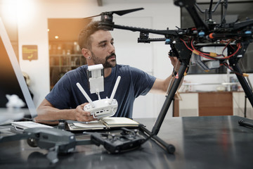 Engineer working on drone in office - obrazy, fototapety, plakaty