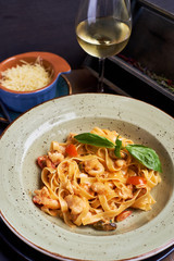 Tagliatelle with prawns and spices in tomato-cream sauce