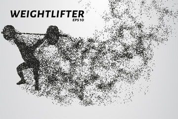 Weightlifting of particles. Athlete raises the bar in the snatch.