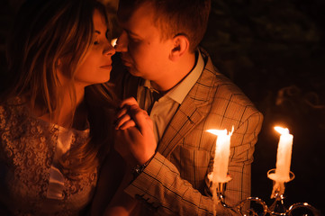 Romantic dinner of a young couple by candlelight in the mountains