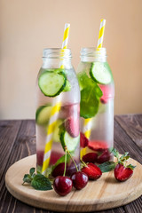 Detox water infused with fruits. Summer water fruit on rustic background