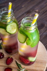 Detox water infused with fruits. Summer water fruit on rustic background