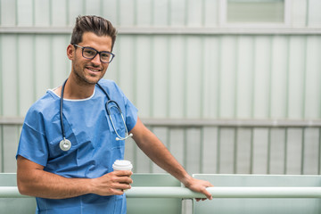 Cheerful medic drinking coffee