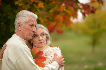 sad senior couple hugging