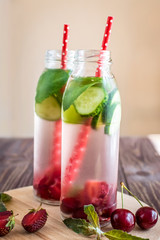 Detox water infused with fruits. Summer water fruit on rustic background