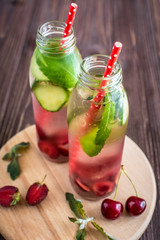 Fototapeta na wymiar Detox water infused with fruits. Summer water fruit on rustic background