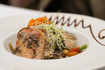 Slice of salmon with sprouts of green peas and vegetables.