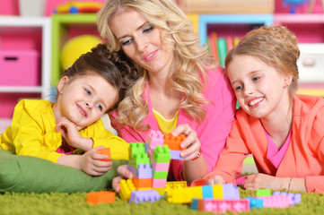 Fototapeta premium young woman playing with daughters