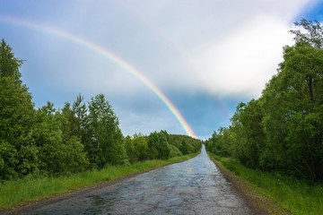 Colorful rainbow over the highway.