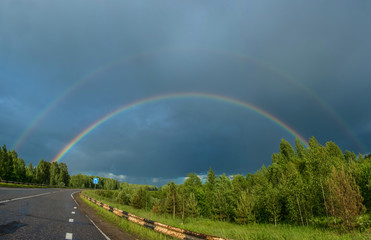 Colorful rainbow over the highway.