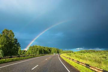 Colorful rainbow over the highway.