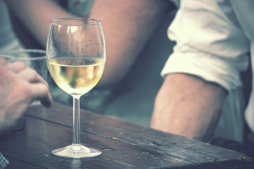 glass of wine vintage effect, the beverage is on wooden table