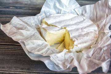 Camembert cheese on wooden background. Top view