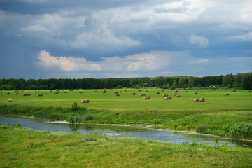 Haystacks in the field, thunderstorm