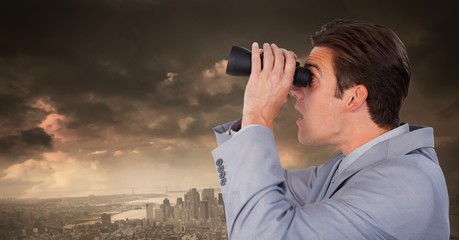 Businessman with binoculars in dramatic city