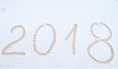 Happy New Year, 2018. New Year inscription on the snow. Winter day. Handwritten 
