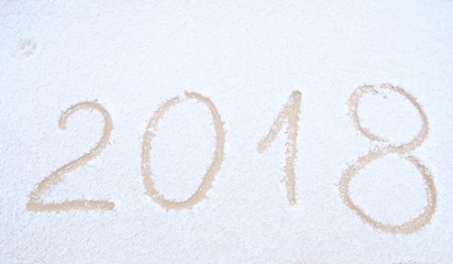 Happy New Year, 2018. New Year inscription on the snow. Winter day. Handwritten 