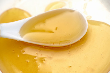 Honey in a plate with a white spoon