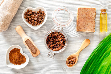 Homemade skin care. Coffee soap, coffee scrub, coffee grains, oil on wooden background top view