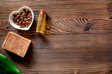 Homemade skin care. Coffee soap on wooden background top view copyspace