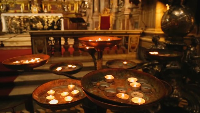 Rounded burning candles standing in front of altar of St. Januarius, faith