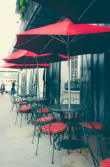 Red umbrellas of a picturesque summer cafe in the French Quarter, New Orleans