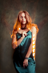 Attractive young woman dancing in blur light at studio