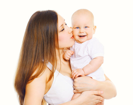 Happy mother kissing her baby on a white background