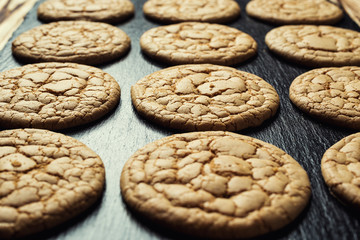Biscuit sweet cookie background. Domestic stacked butter biscuit pattern concept,close up macro.Homemade cookies on wooden table.Cereal biscuits with the sesame,peanuts,sunflower and amaranth.