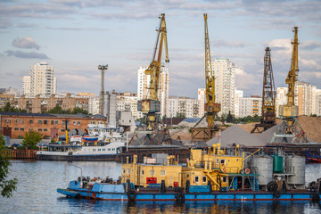 Loading and unloading of sand by crane.