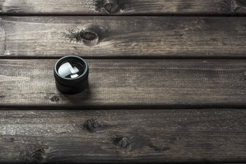 magnifying glass on the dark brown wooden background