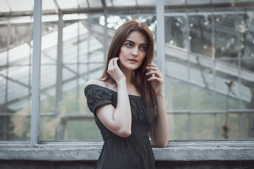 Fototapeta premium Fashionable model in dress at the window